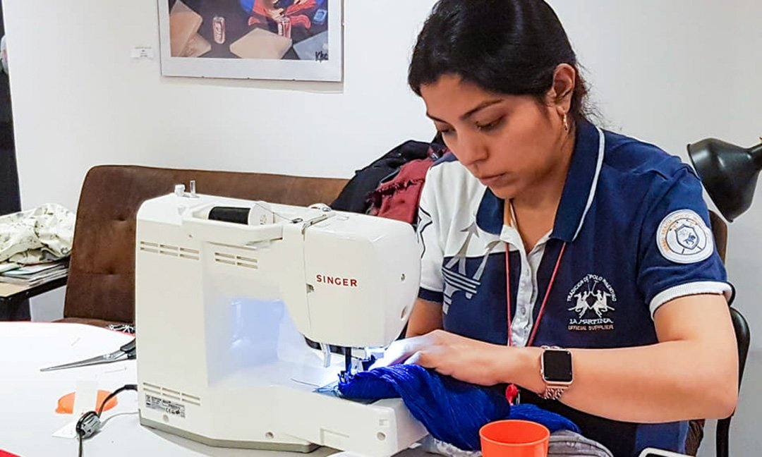 une apprenti cousant sur une machine a coudre singer Cours de couture à Paris